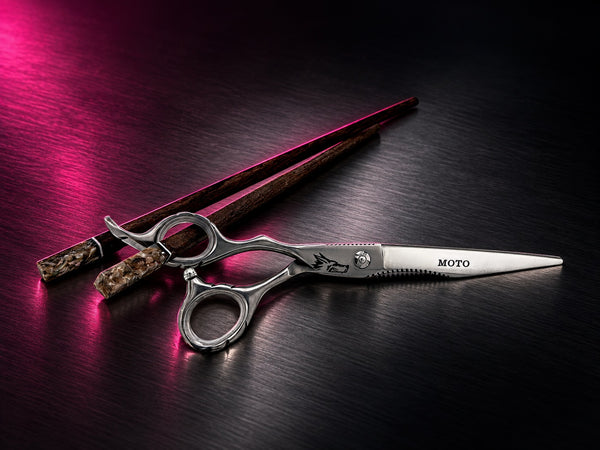 Moto Polished 440c Power Shear, 7-inch, left-handed, on dark brushed steel under magenta light